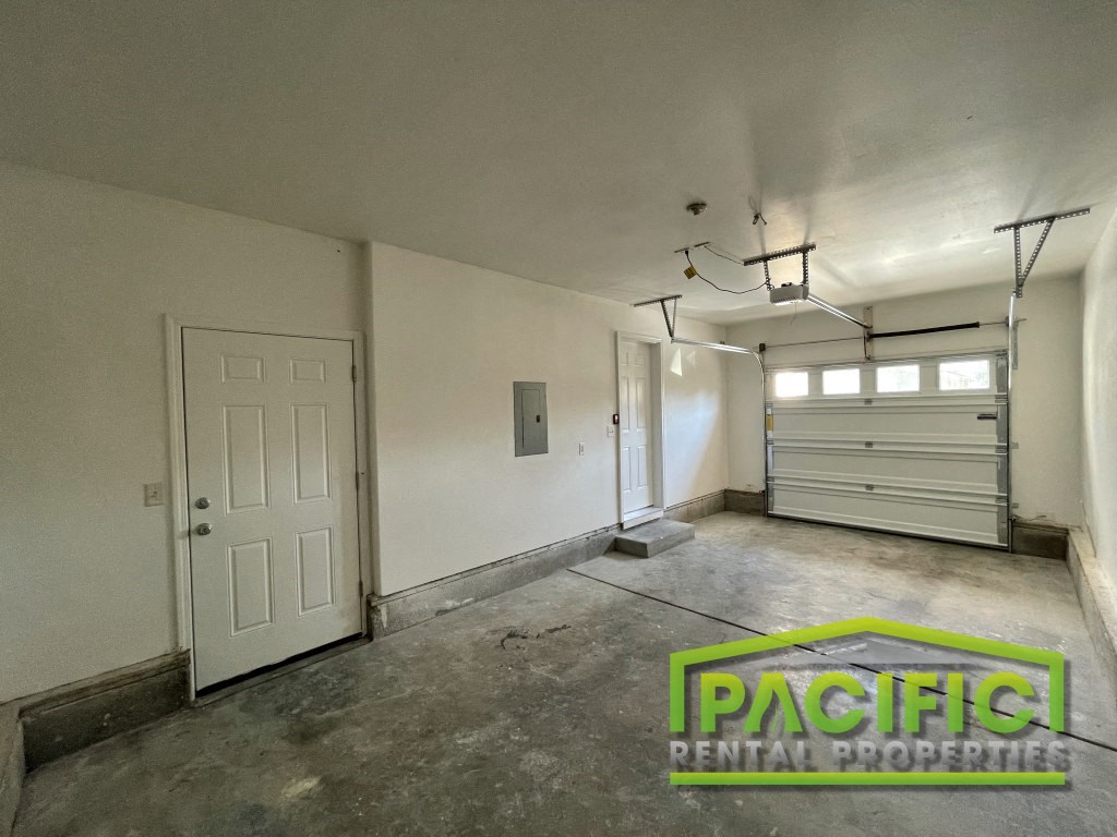 the interior of a garage with a white wall and a door