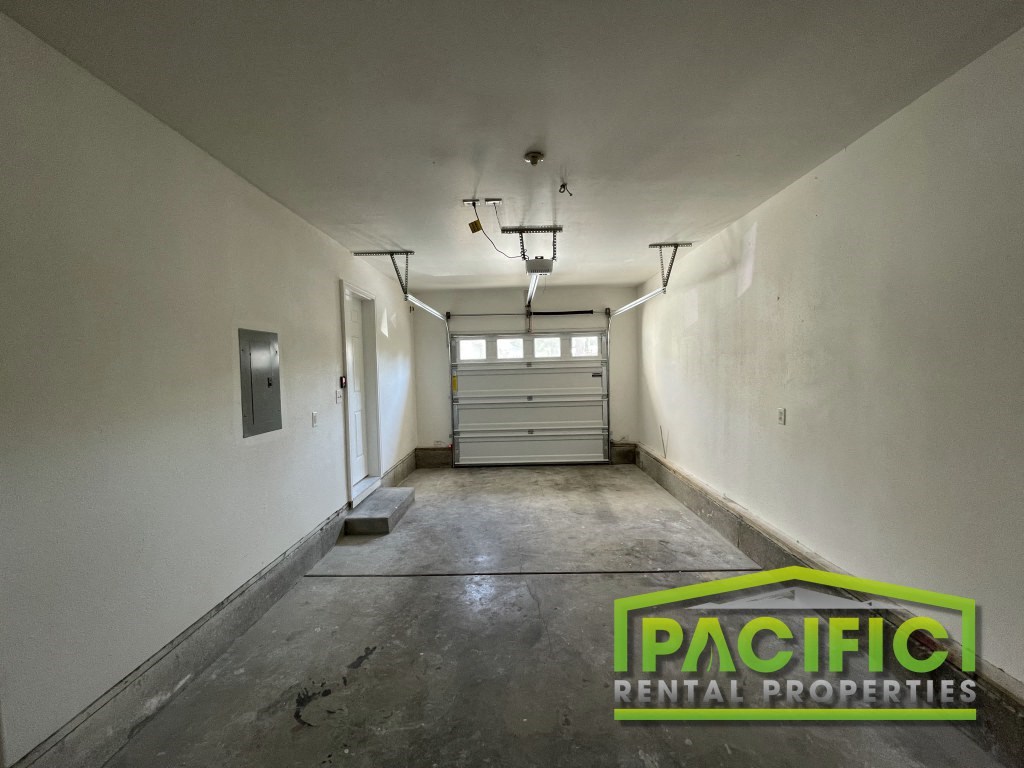 a empty garage with a white wall and a garage door