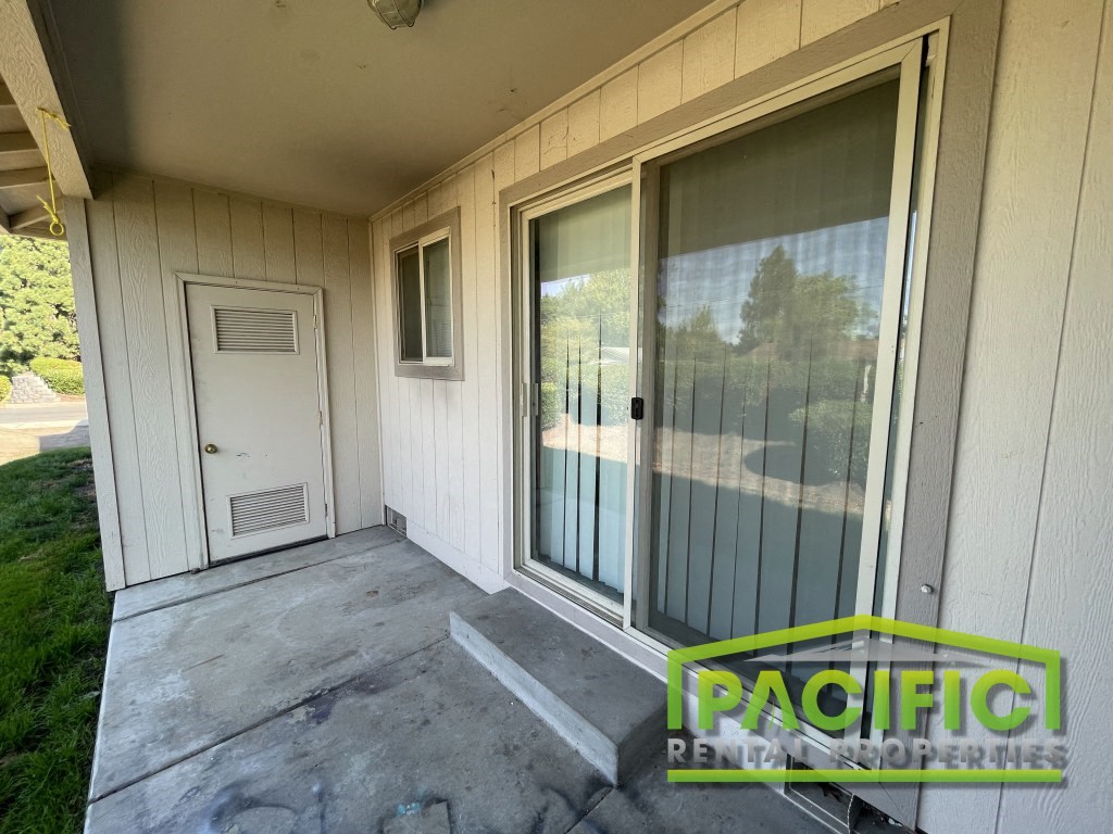 the front porch of a manufactured home with a white door
