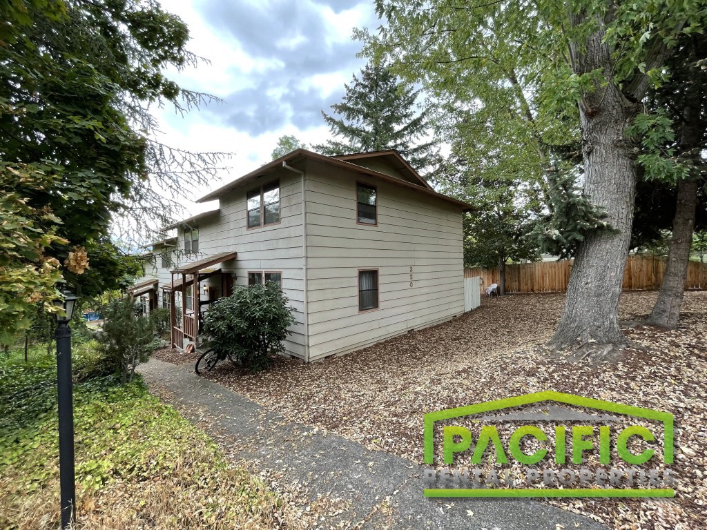 a house with a bike parked next to a tree