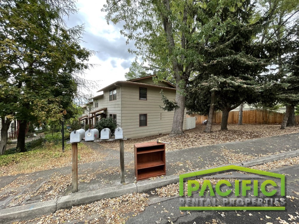 a house with mailboxes on the side of a road