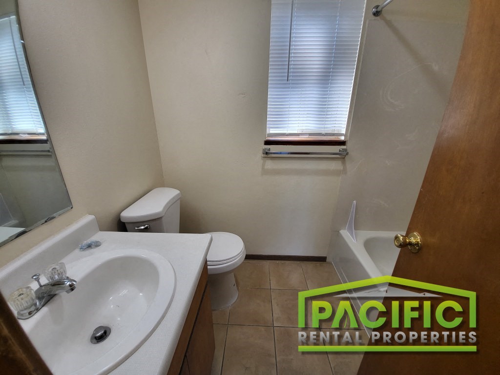 a bathroom with a sink toilet and a mirror