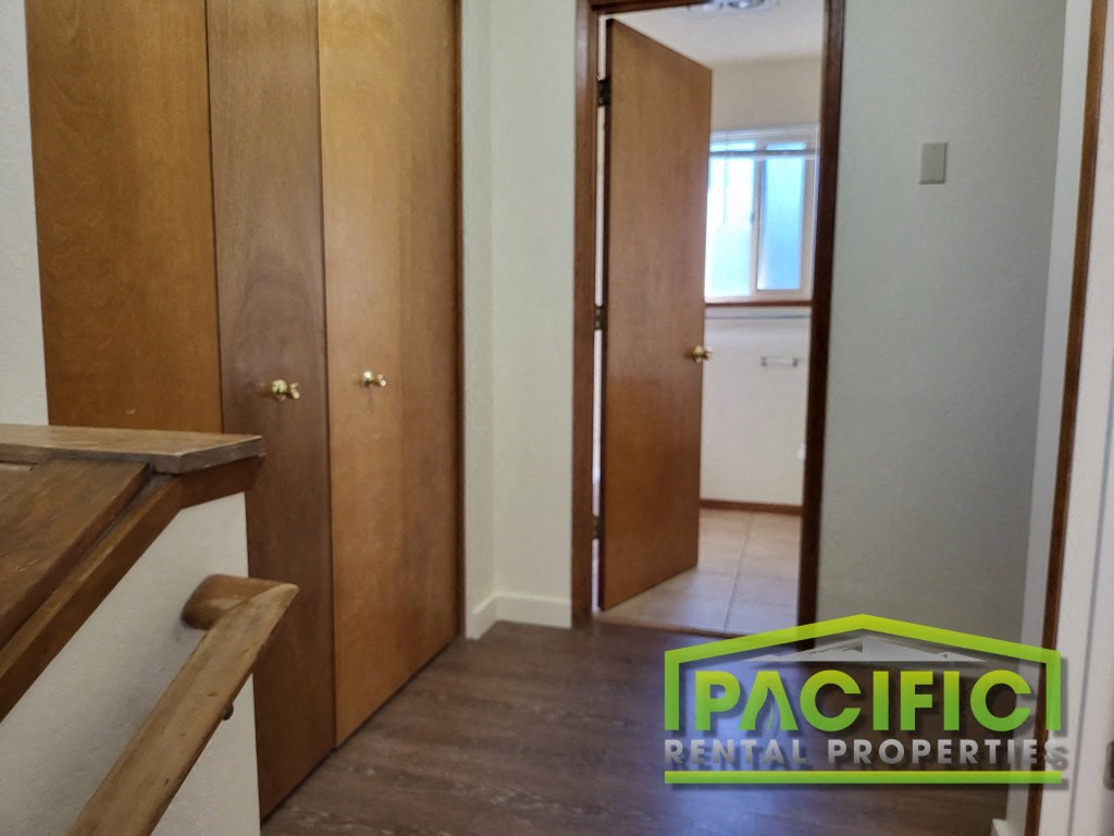a small hallway with a closet and a door to a bathroom