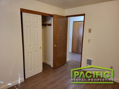 a bedroom with a closet and an open door