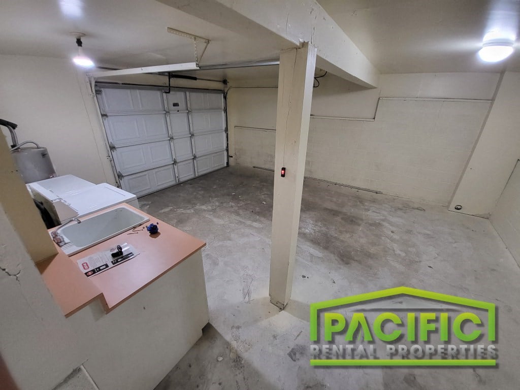 the interior of a garage with a sink and a counter