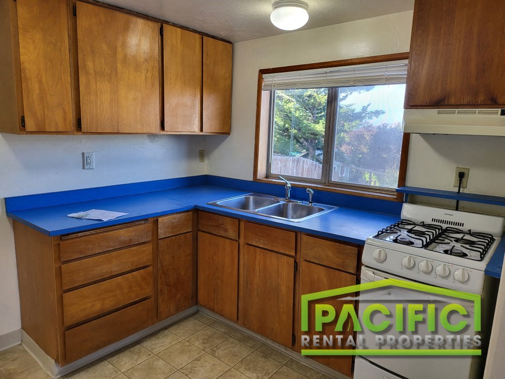 a kitchen with a blue counter top and a window