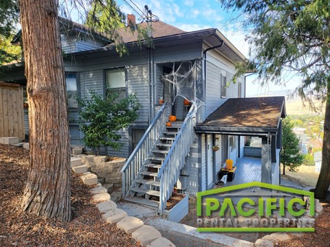 the front of a house with a porch and stairs