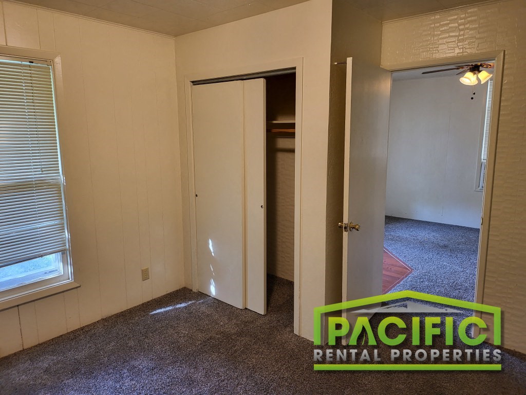 a bedroom with a closet and a door to a bathroom