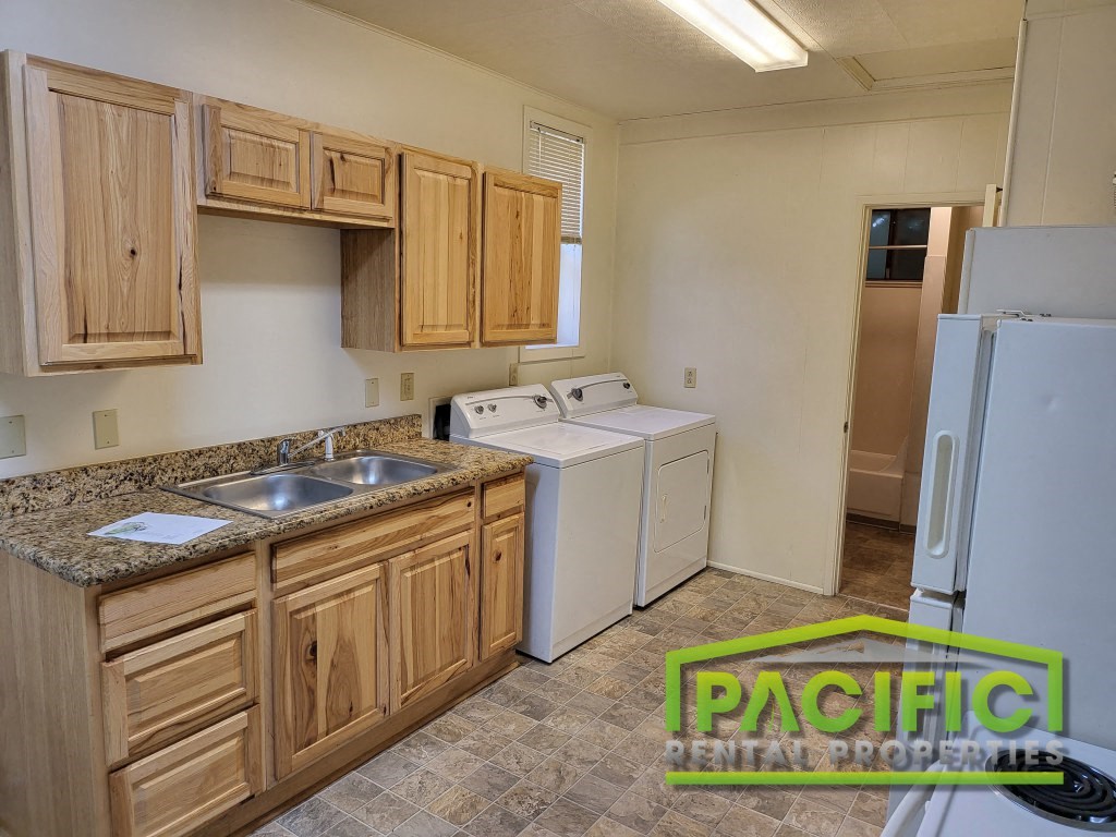 a kitchen with wooden cabinets and a white refrigerator