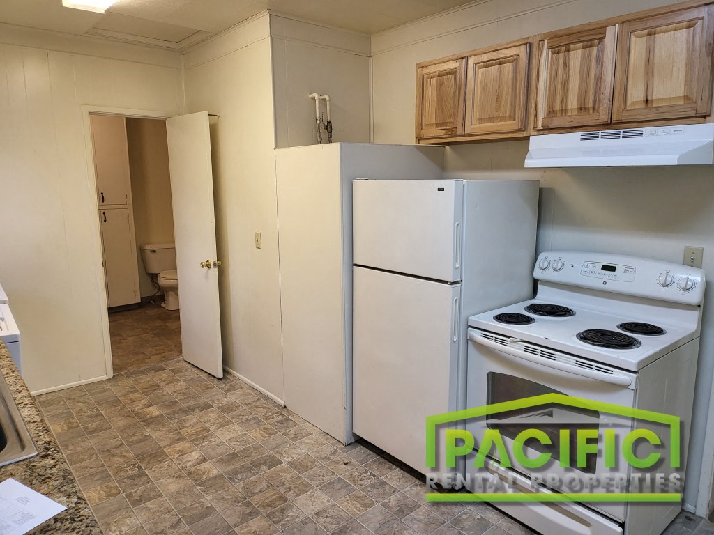 a kitchen with a stove and a refrigerator