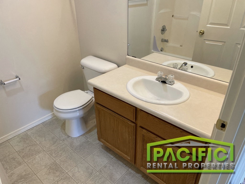 a bathroom with a sink toilet and a mirror