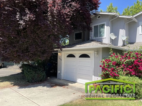 A house with a white garage door is for sale.