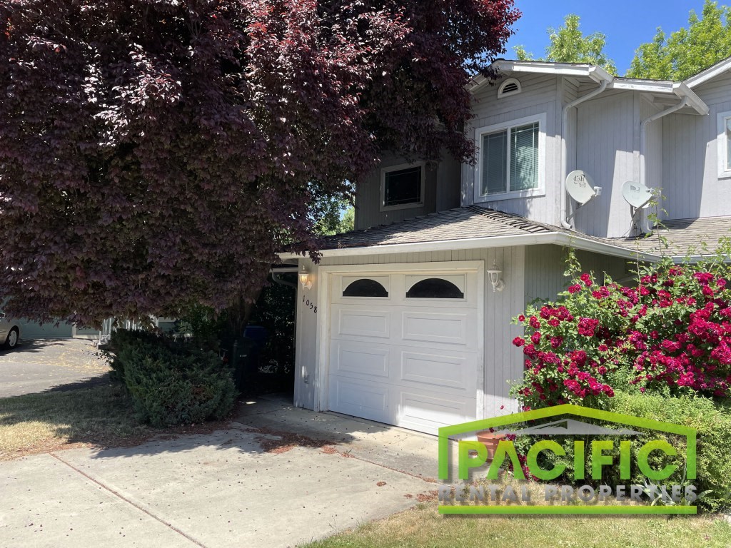 A house with a white garage door is for sale.