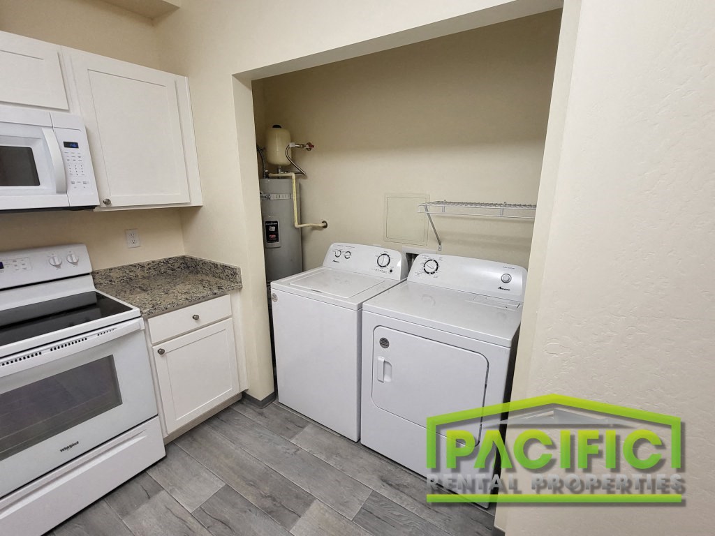 a washer and dryer in a laundry room with white appliances