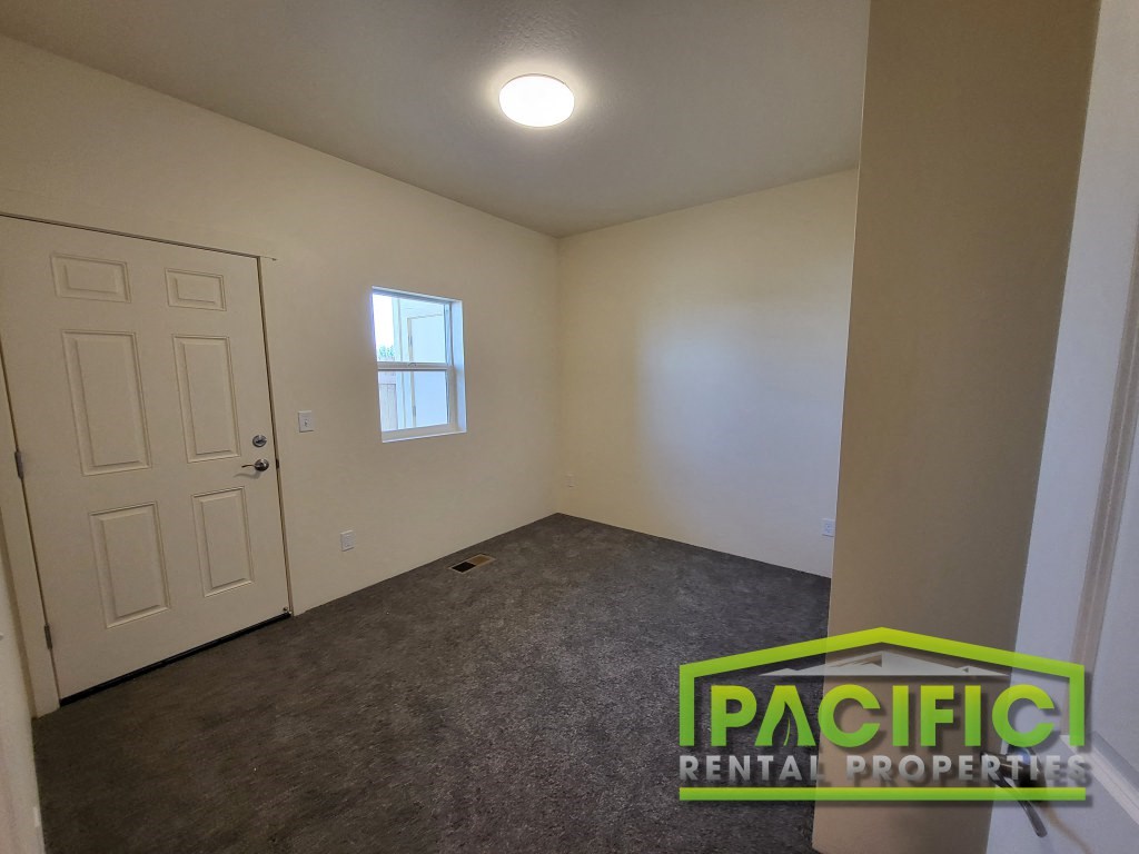 a room with a carpeted floor and a white door