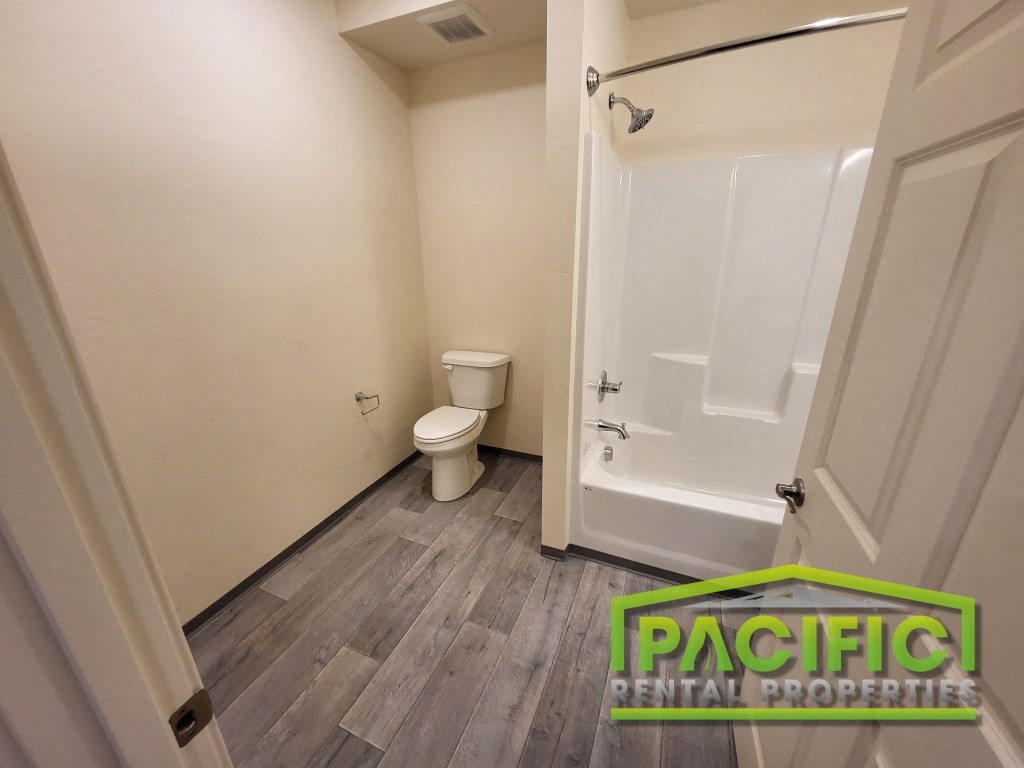 a bathroom with a toilet and a bath tub