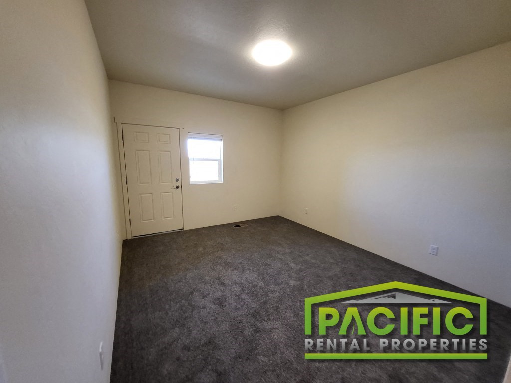 the interior of a room with a carpeted floor and a door