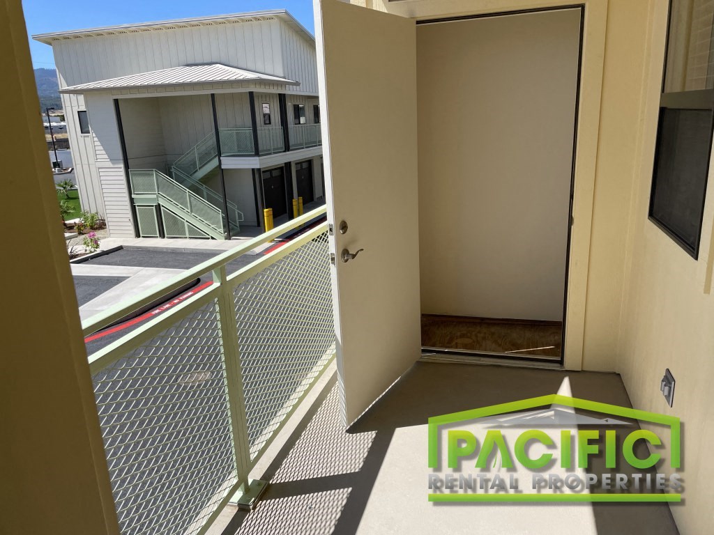 a balcony with an open door and a building in the background