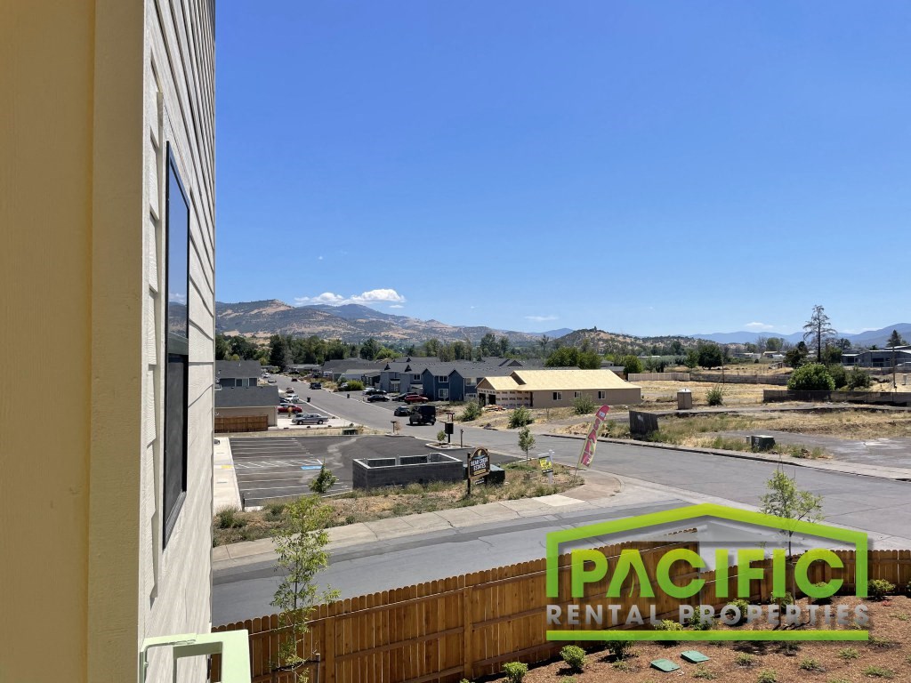 a view of a parking lot from the balcony of a building