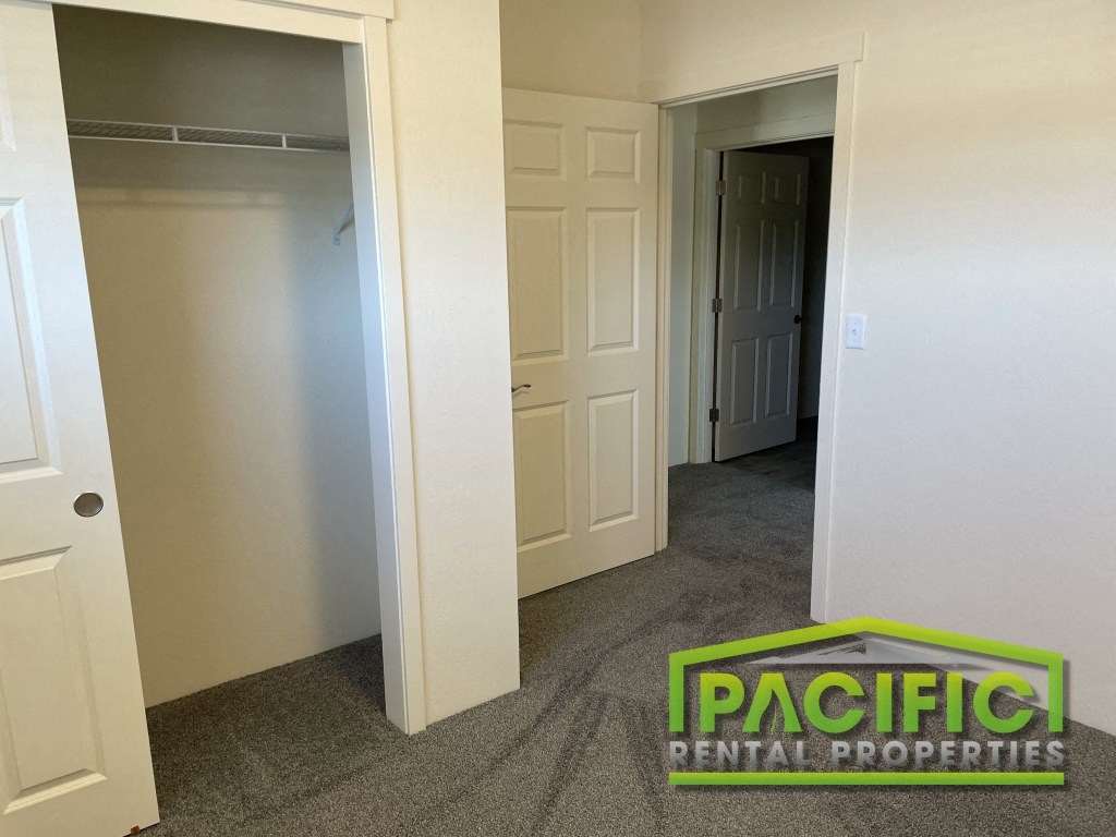 a bedroom with a closet and a rug on the floor