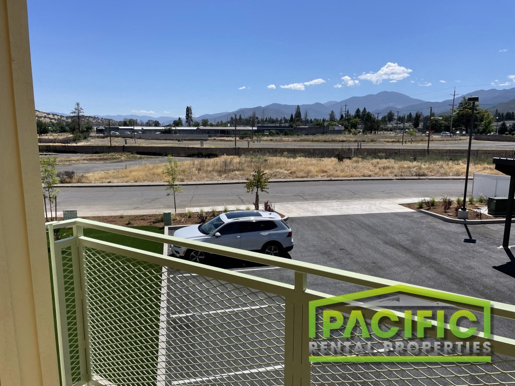 a car parked in a parking lot in front of a building