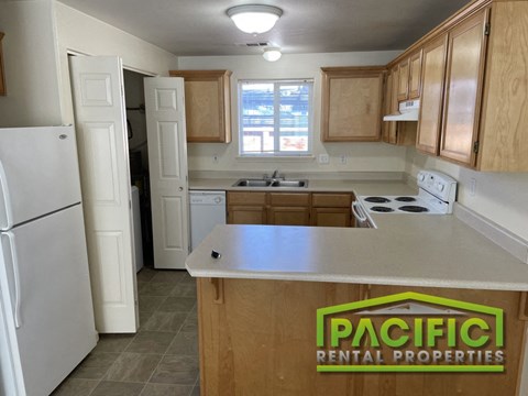 a kitchen with wooden cabinets and a white counter top