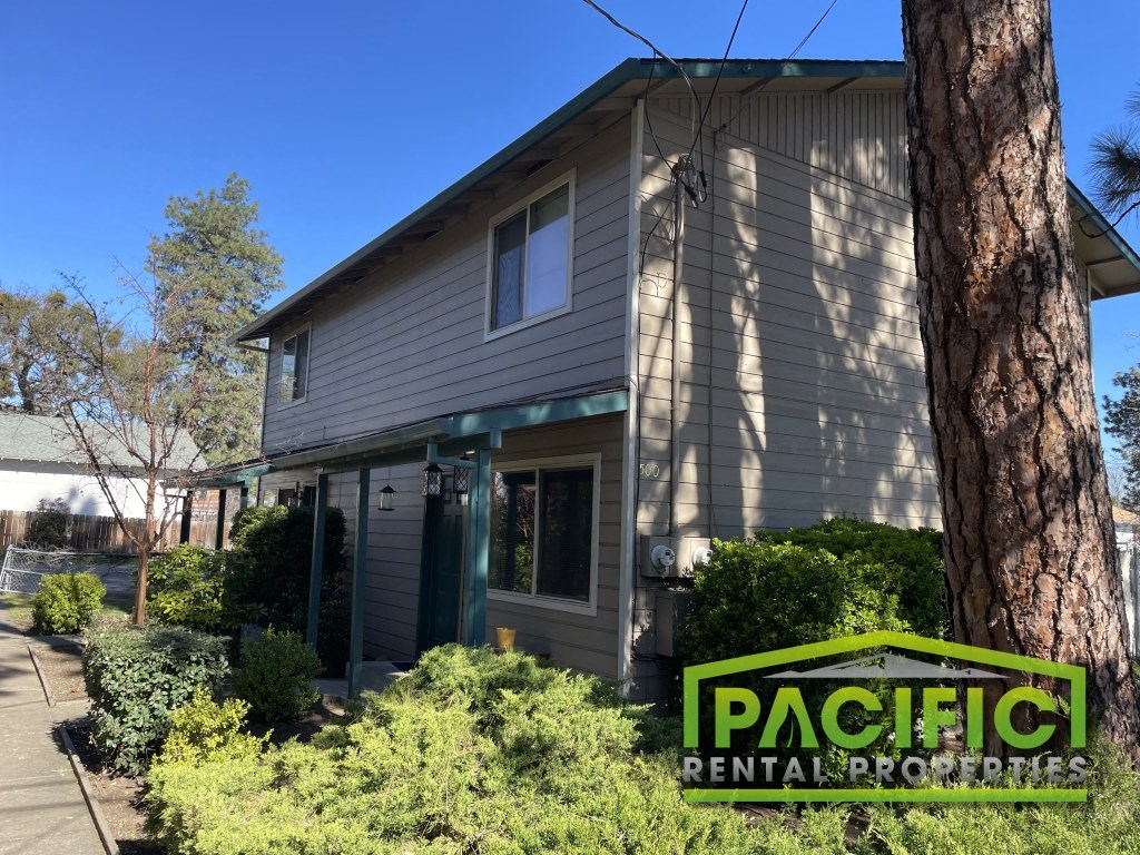 a house with a pacific rentals sign in front of it