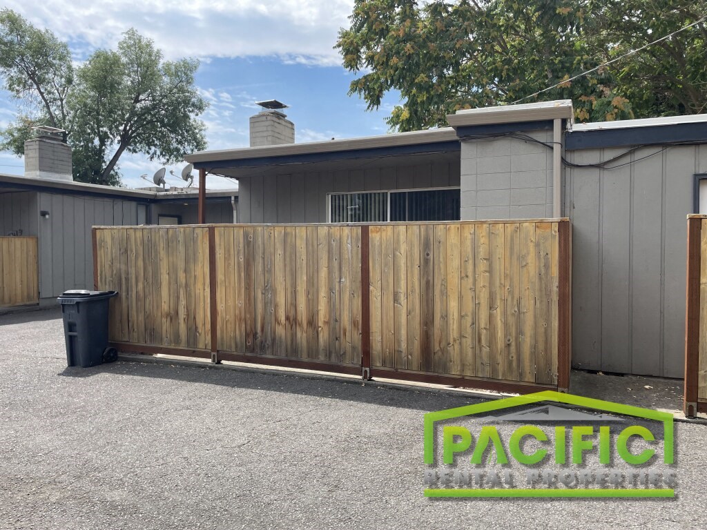 a wood privacy fence in front of a house