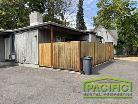 a wooden privacy fence in front of a house