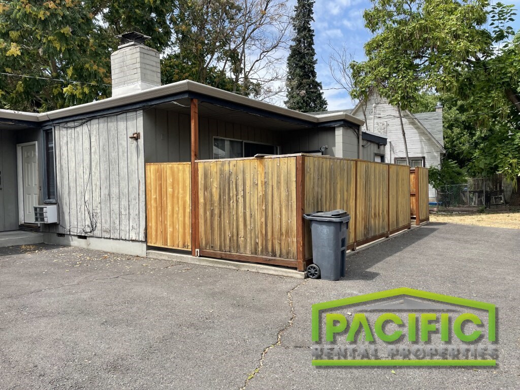 a wooden privacy fence in front of a house