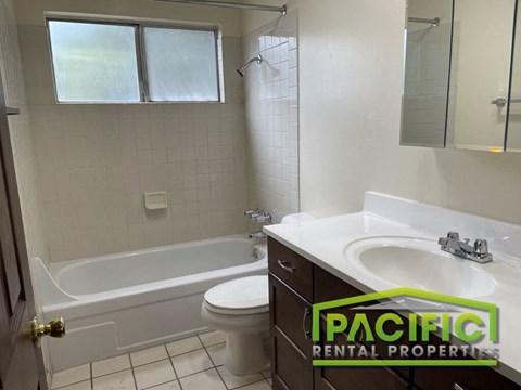 a bathroom with a sink toilet and a bath tub