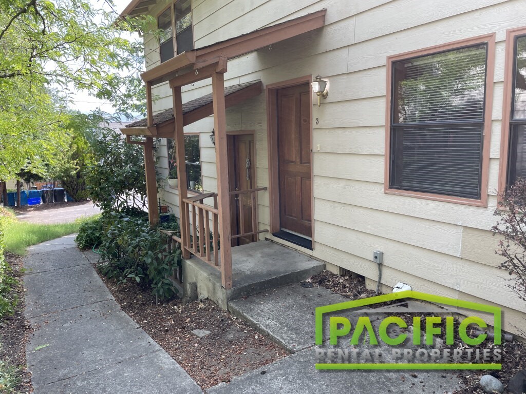 a front porch of a house with a wooden door