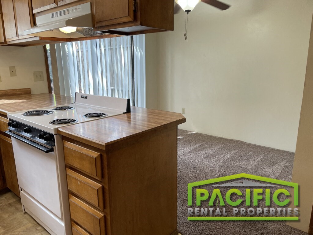 a kitchen with a stove and a counter top in a house