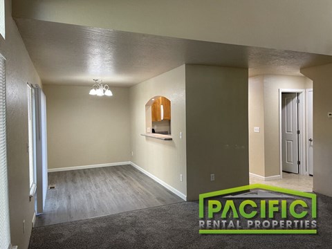 the living room and dining room of a new home