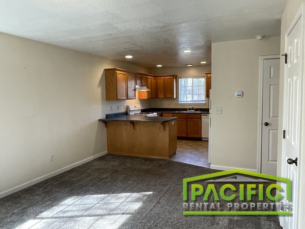 A kitchen area with a counter and cabinets is shown in the image.