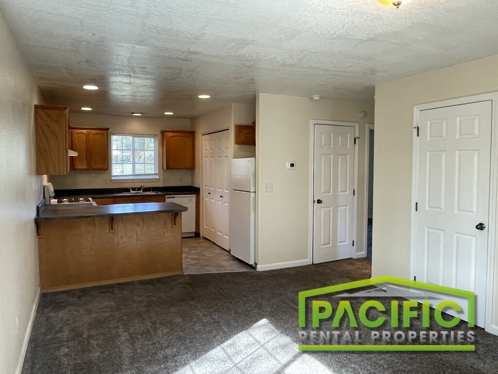 A kitchen with a washer and dryer built in.