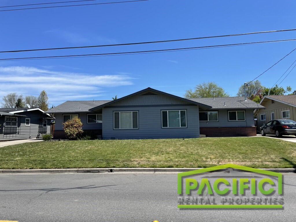 A house with a sign that says Pacific in front of it.