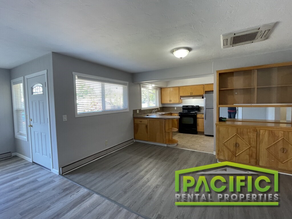A kitchen area with wooden cabinets and a countertop is shown in the image.