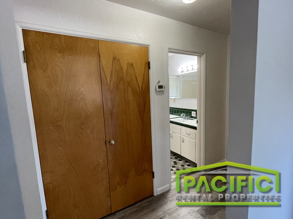 A wooden door with a glass window in the middle.