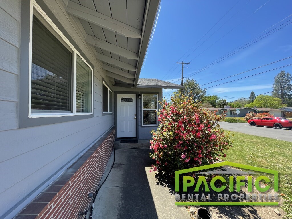 A house with a sign that says "Pacific Rental Properties".