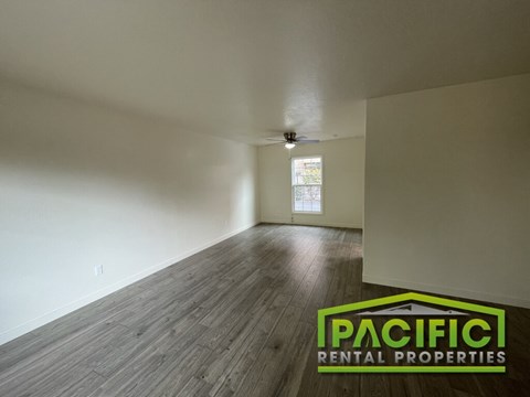 A room with wooden flooring and a window is for rent.