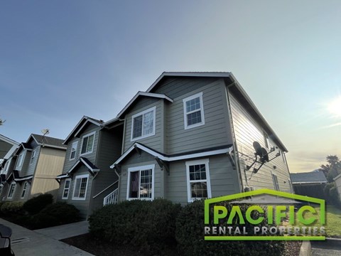 A house with the words "Pacific Rental Properties" in front of it.