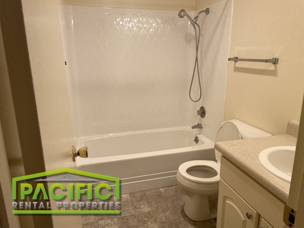 a bathroom with a tub and a toilet and a sink