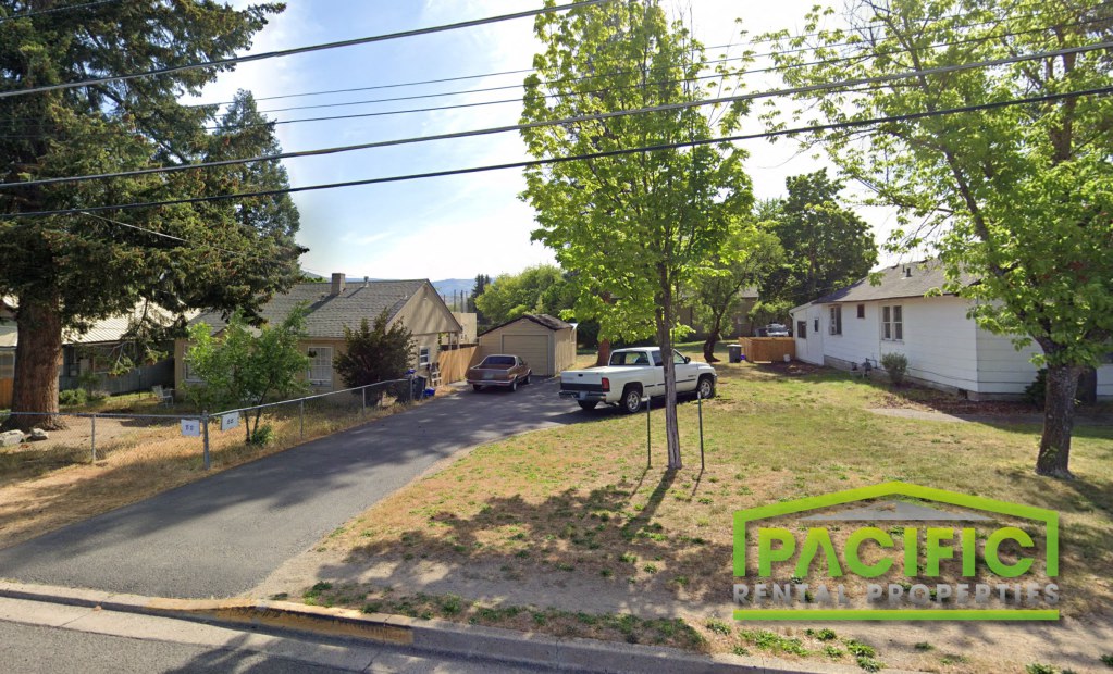 a street with a white truck parked on the side of the road