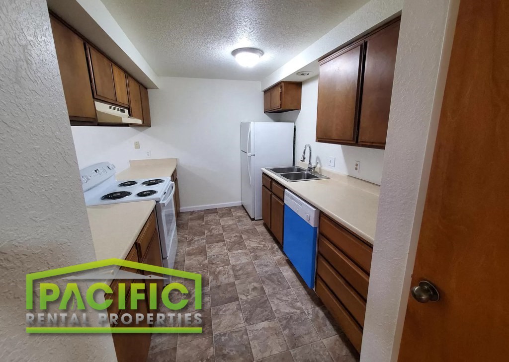 a kitchen with a stove and a refrigerator