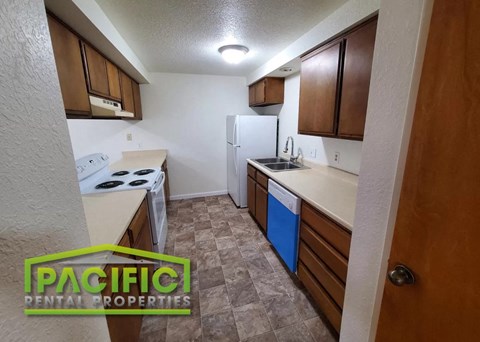 a kitchen with a stove and a refrigerator