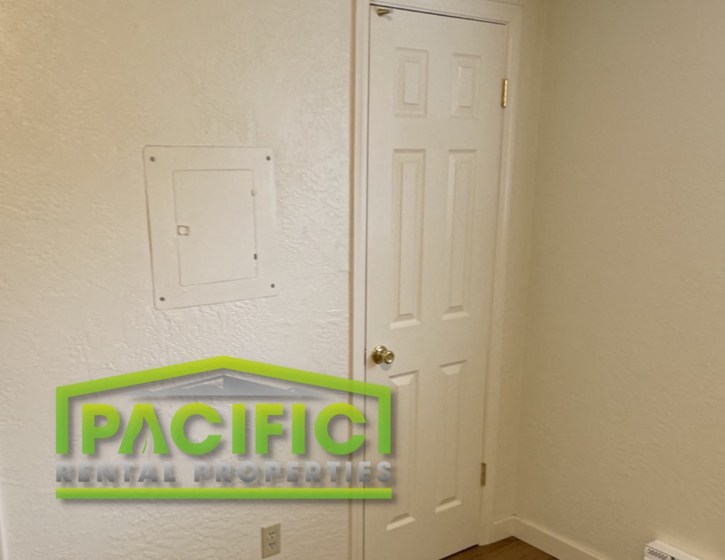 a room with a door and a pacific small properties logo on it