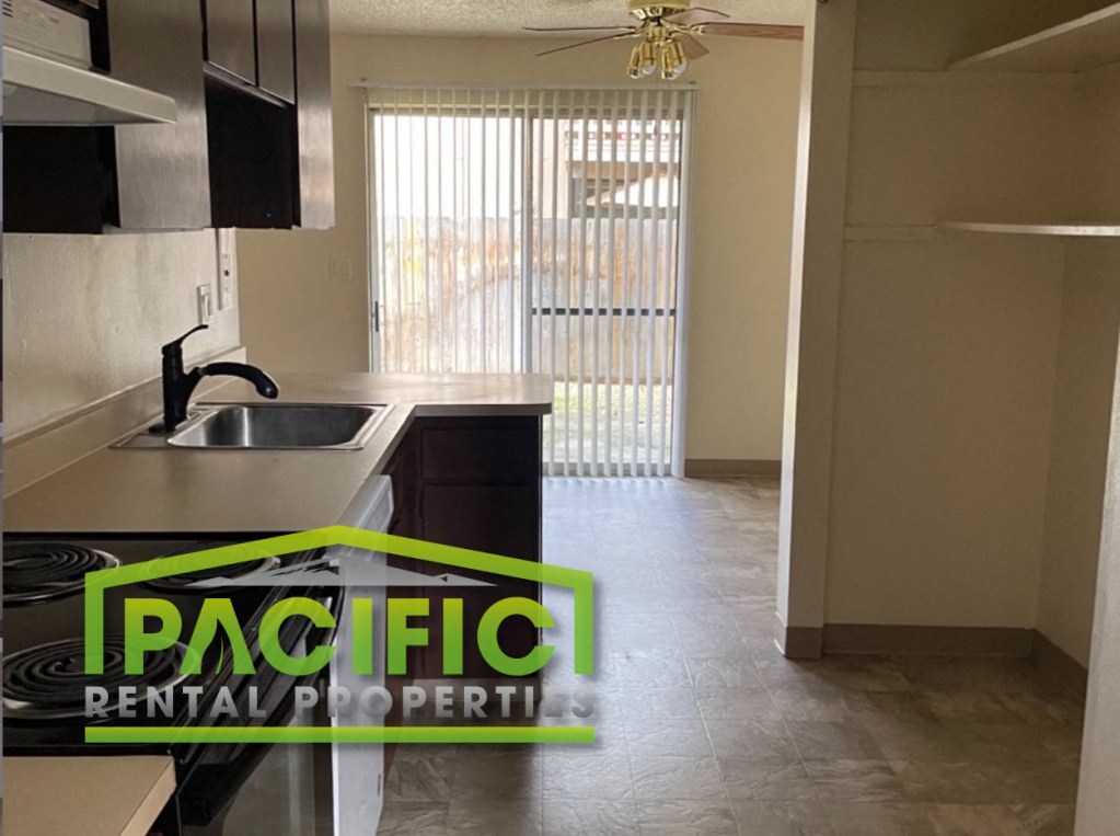 an empty kitchen with a sink and a window