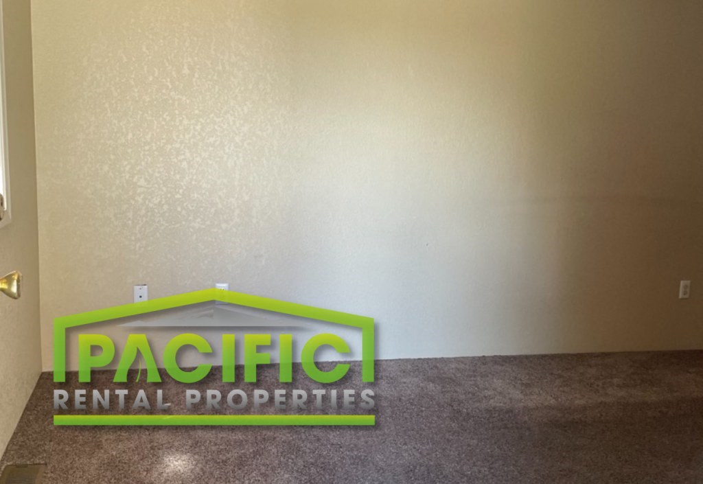 the logo of pacific rental properties on the floor of a room