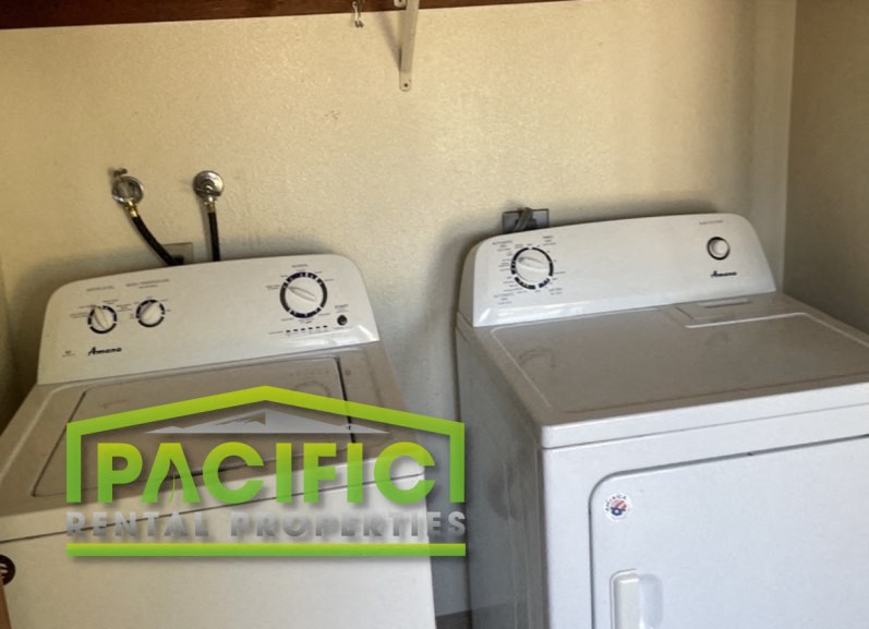 a washer and dryer in the corner of a room